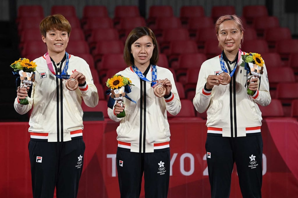 Hong Kong’s Doo Hoi-kem, Lee Ho-ching, and Minnie Soo Wai-yam with their bronze medals at the Tokyo Olympics. Photo: AFP Hong Kong’s Doo Hoi-kem, Lee Ho-ching, and Minnie Soo Wai-yam with their bronze medals at the Tokyo Olympics. Photo: AFP