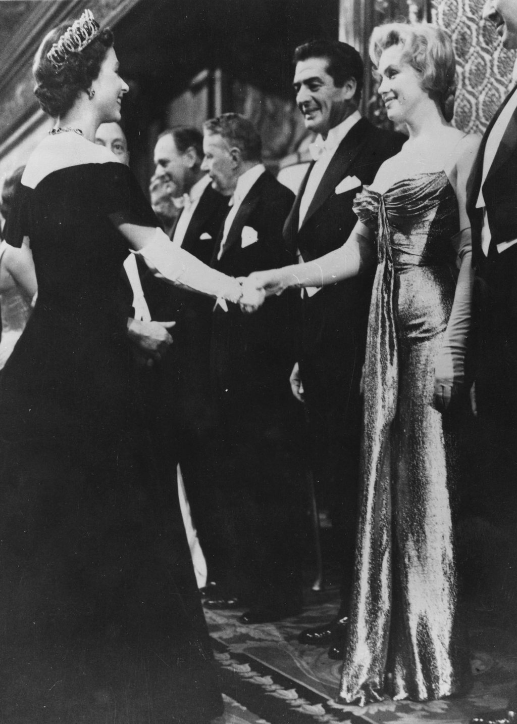 Queen Elizabeth shaking hands with Marilyn Monroe who stands next to Victor Mature at a Royal Film Performance of The Battle of the River Plate at the Empire Theatre, Leicester Square, in London, in 1956. Photo: Getty Images Queen Elizabeth shaking hands with Marilyn Monroe who stands next to Victor Mature at a Royal Film Performance of The Battle of the River Plate at the Empire Theatre, Leicester Square, in London, in 1956. Photo: Getty Images
