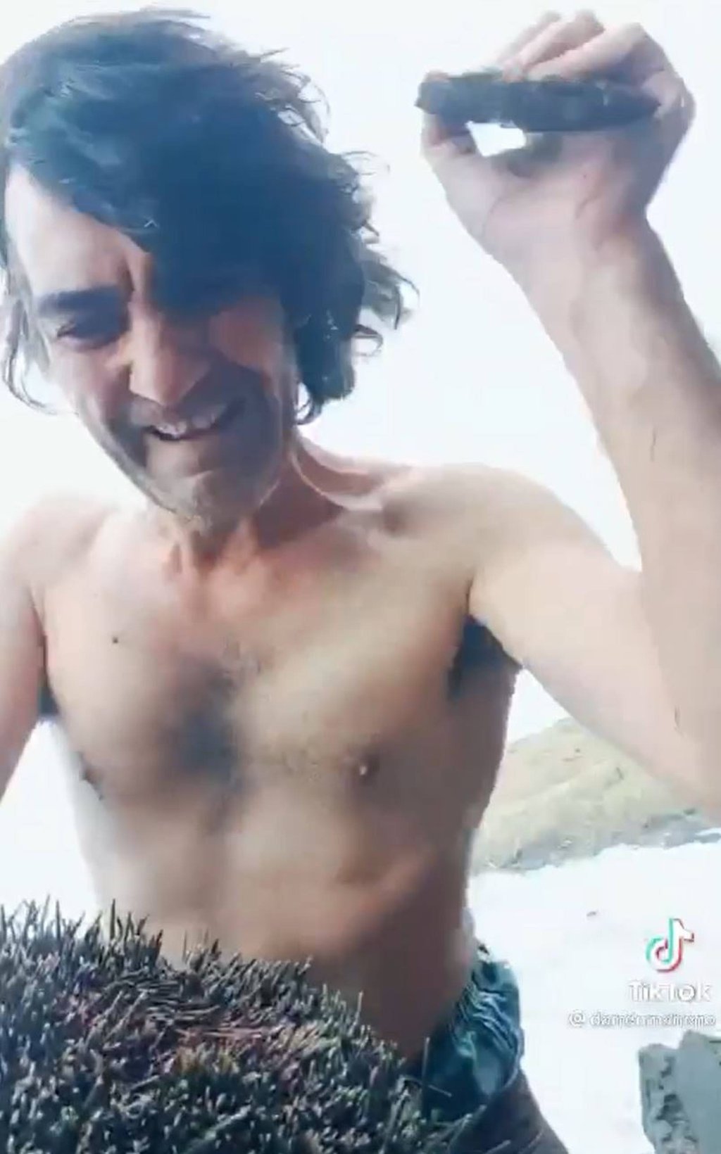 Maheno smashes open a sea urchin in a screengrab from the last video he posted to TikTok. Photo: TikTok/@darrenmaheno Maheno smashes open a sea urchin in a screengrab from the last video he posted to TikTok. Photo: TikTok/@darrenmaheno