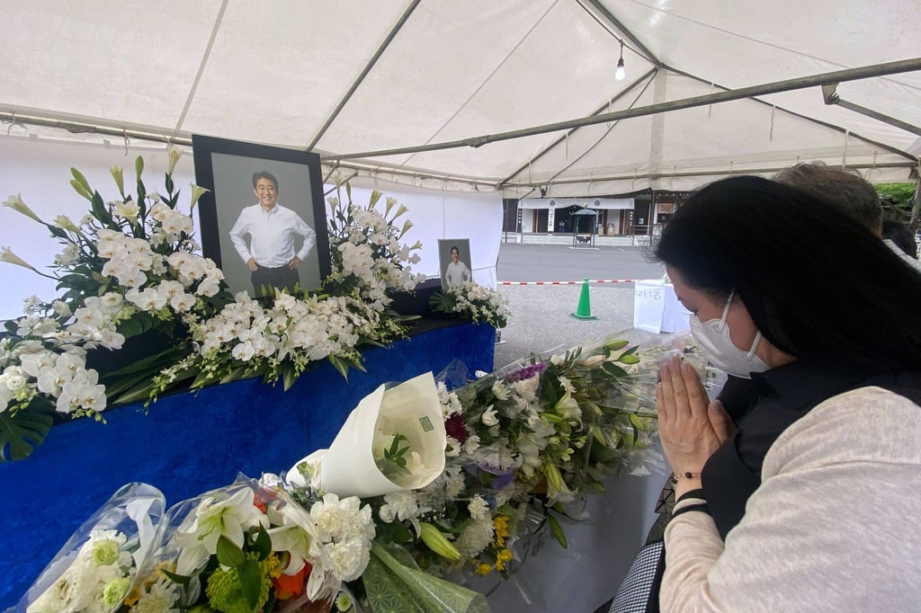 A mourner pays tribute to the late former Prime Minister Shinzo Abe at a makeshift memorial in Tokyo in July. Photo: Bloomberg