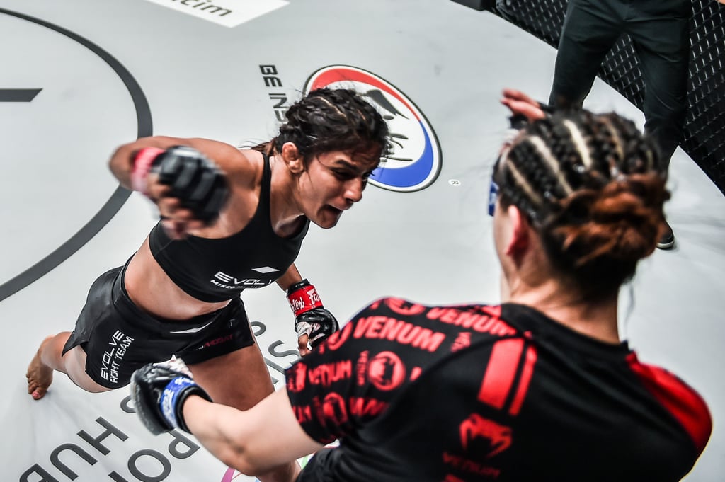 India’s Ritu Phogat throws an overhand right at China’s Lin Heqin.