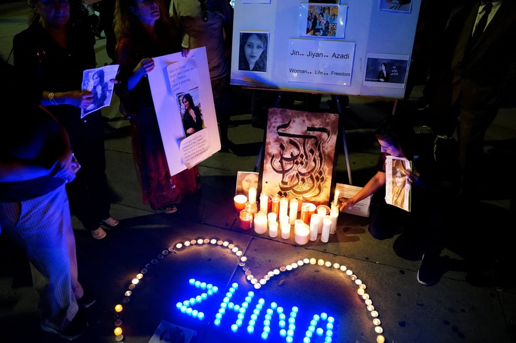 People demonstrate during a candlelit vigil following the death of Mahsa Amini, also known as Zhina, outside the Wilshire Federal Building in Los Angeles. Photo: Reuters People demonstrate during a candlelit vigil following the death of Mahsa Amini, also known as Zhina, outside the Wilshire Federal Building in Los Angeles. Photo: Reuters