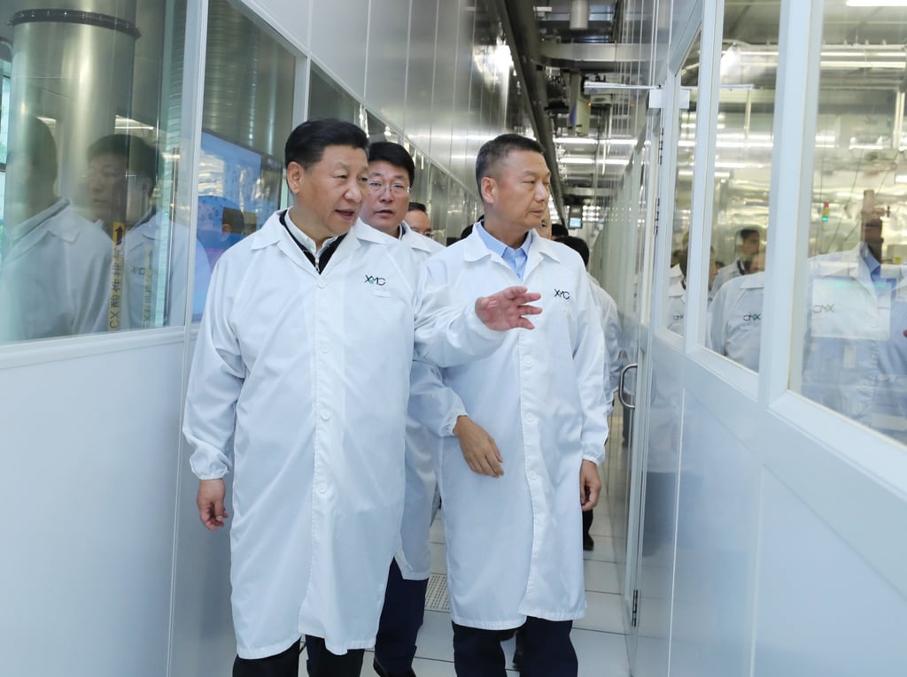 Chinese President Xi Jinping, with then-Tsinghua Unigroup chairman Zhao Weiguo directly behind him, visits the facilities of Wuhan Xinxin Semiconductor Manufacturing Corp, a subsidiary of Yangtze Memory Technologies Co, in Wuhan, capital of central Hubei province, on April 26, 2018. Photo: Xinhua Chinese President Xi Jinping, with then-Tsinghua Unigroup chairman Zhao Weiguo directly behind him, visits the facilities of Wuhan Xinxin Semiconductor Manufacturing Corp, a subsidiary of Yangtze Memory Technologies Co, in Wuhan, capital of central Hubei province, on April 26, 2018. Photo: Xinhua