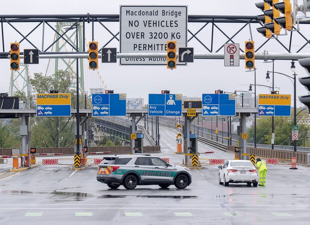 Police block lanes of traffic as both Halifax harbour bridges are closed in Dartmouth, Nova Scotia, on Saturday. Photo: The Canadian Press via AP Police block lanes of traffic as both Halifax harbour bridges are closed in Dartmouth, Nova Scotia, on Saturday. Photo: The Canadian Press via AP