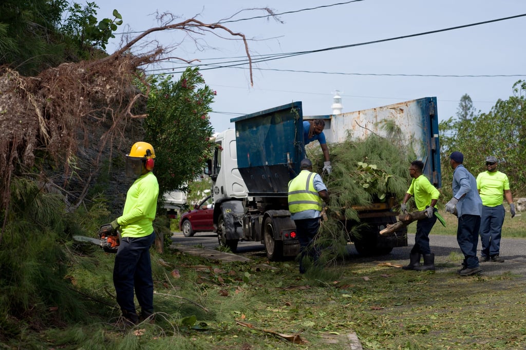 A work crew clears debris after high winds from Hurricane Fiona hit the south shore of Bermuda on Friday. Photo: Reuters