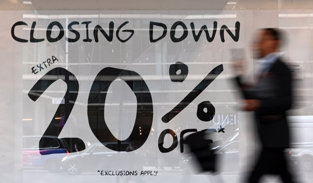 A pedestrian passes a closed-down retail store in London, on September 1. Britain is expected to fall into recession by the end of this year and will remain there until 2024, the Bank of England has said. Photo: EPA-EFE