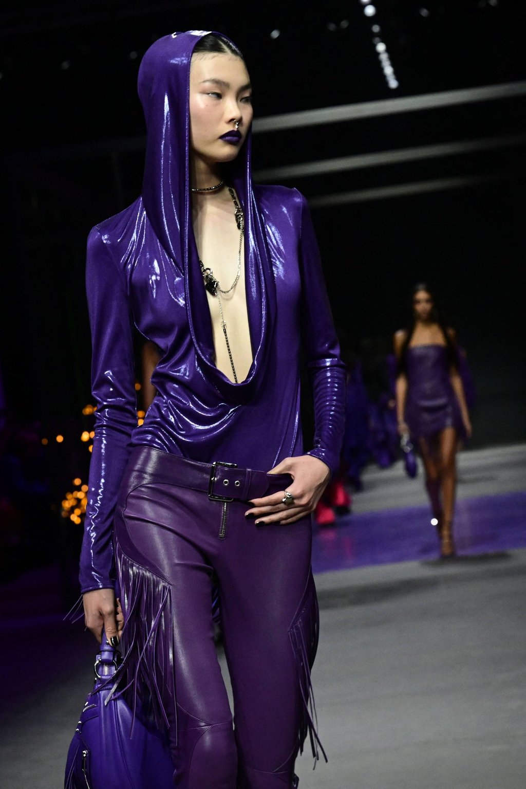 A top with an oil slick shine features in this all purple look, which gives off cyberpunk vibes, from Versace’s women’s spring/summer 2023 fashion collection presented on September 23, as part of the Fashion Week in Milan. Photo: AFP