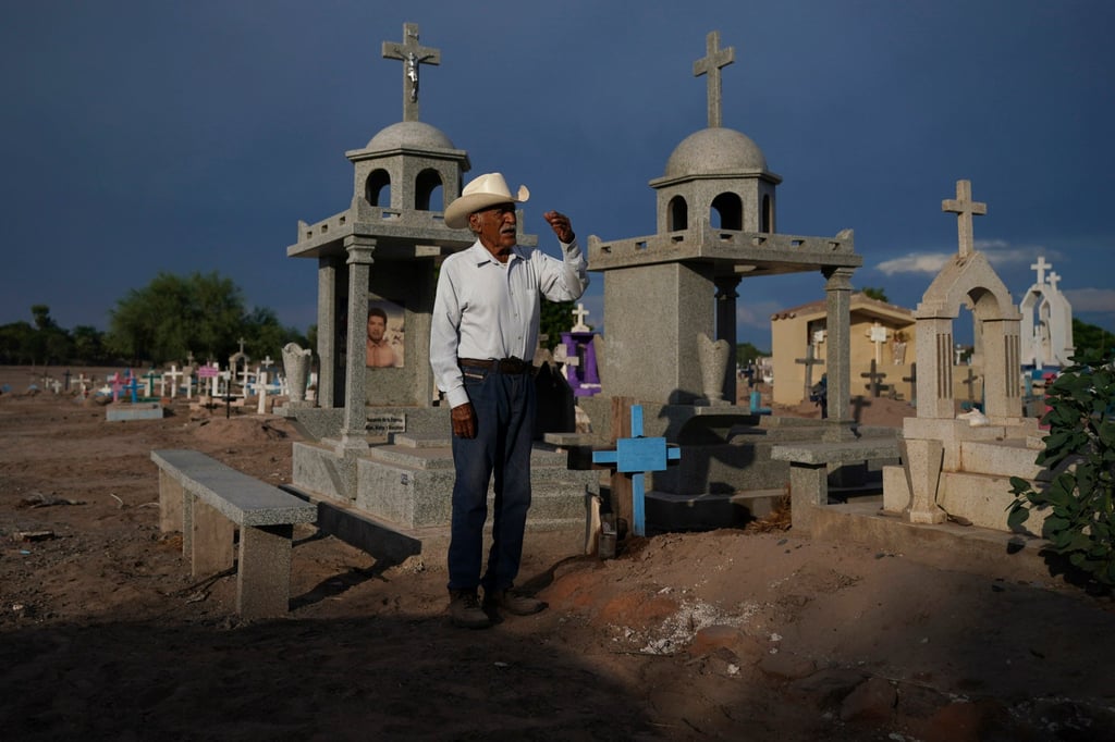 Guillermo Rojo, the father of murdered water defence leader Tomás, prays next to his tomb in Potam, Mexico. Photo: AP