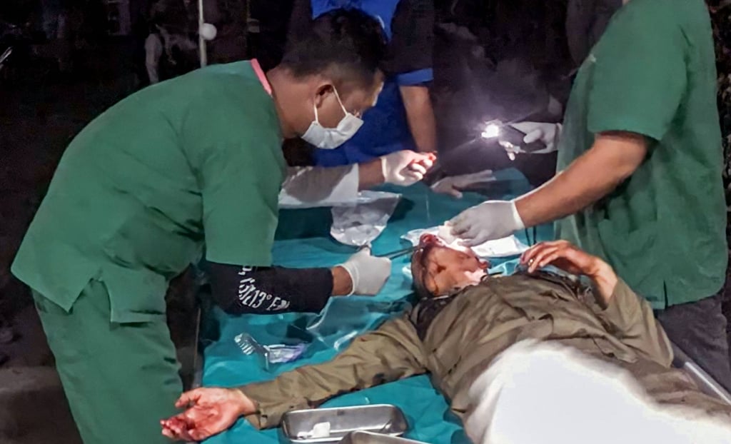 Medical workers treat a survivor, injured from falling debris from buildings after an earthquake in North Tapanuli in northern Sumatra on Saturday. Photo: AFP/BPBD