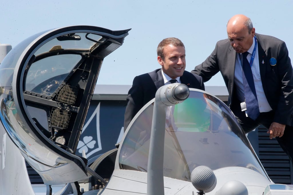 French President Emmanuel Macron exits the cockpit of a Rafale jet fighter helped by Dassault Aviation CEO Eric Trappier (right) while visiting the Paris Air Show in Le Bourget in 2017. Macron had made concessions on the stalled sale of Rafales to the UAE, leading to the surprise signing of a €17 billion contract for 80 of the warplanes last December. Photo: EPA