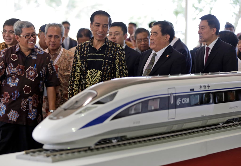 Indonesian President Joko Widodo, centre, inspects a model of the high-speed train which will Jakarta to the country’s fourth largest city, Bandung during the groundbreaking ceremony for the construction of its railway in West Java, Indonesia on January 21, 2016. Photo: AP/File Indonesian President Joko Widodo, centre, inspects a model of the high-speed train which will Jakarta to the country’s fourth largest city, Bandung during the groundbreaking ceremony for the construction of its railway in West Java, Indonesia on January 21, 2016. Photo: AP/File