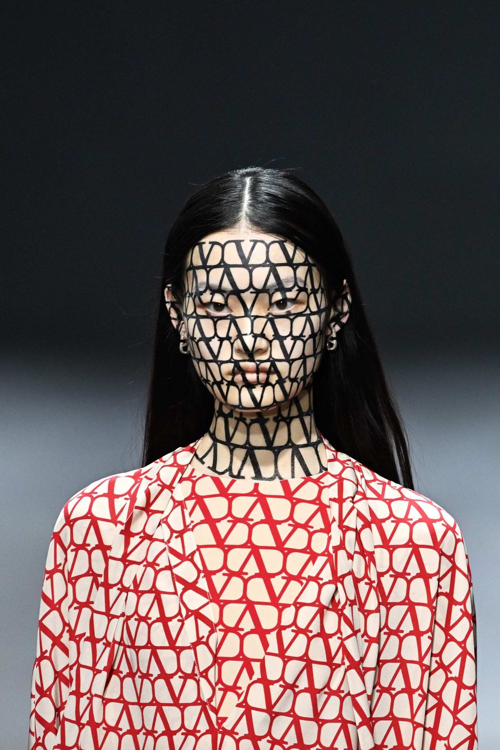 A model with a bold “V” cut-out imprinted on her face for Valentino during the spring-summer 2023 fashion show as part of Paris Fashion Week, in Paris, on October 2. Photo: AFP