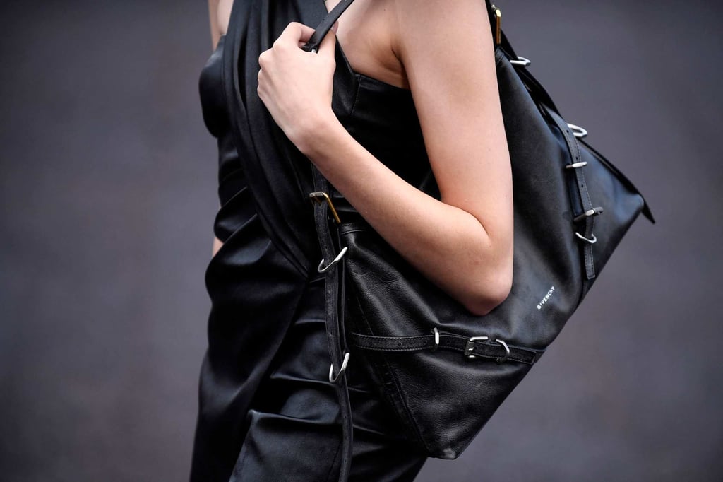 A model slings a black strappy bag over the shoulder for Givenchy during the spring-summer 2023 fashion show as part of the Paris Womenswear Fashion Week, in Paris, on October 2. Photo: AFP A model slings a black strappy bag over the shoulder for Givenchy during the spring-summer 2023 fashion show as part of the Paris Womenswear Fashion Week, in Paris, on October 2. Photo: AFP
