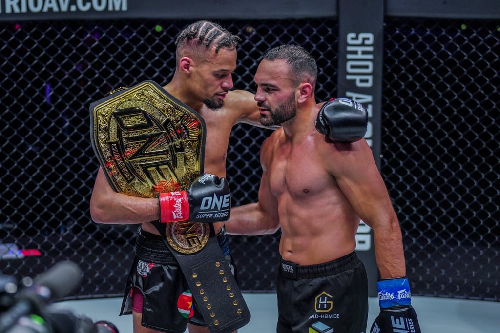 Regian Eersel and Arian Sadikovic embrace after their lightweight kick-boxing title fight at ONE 156 in Singapore.