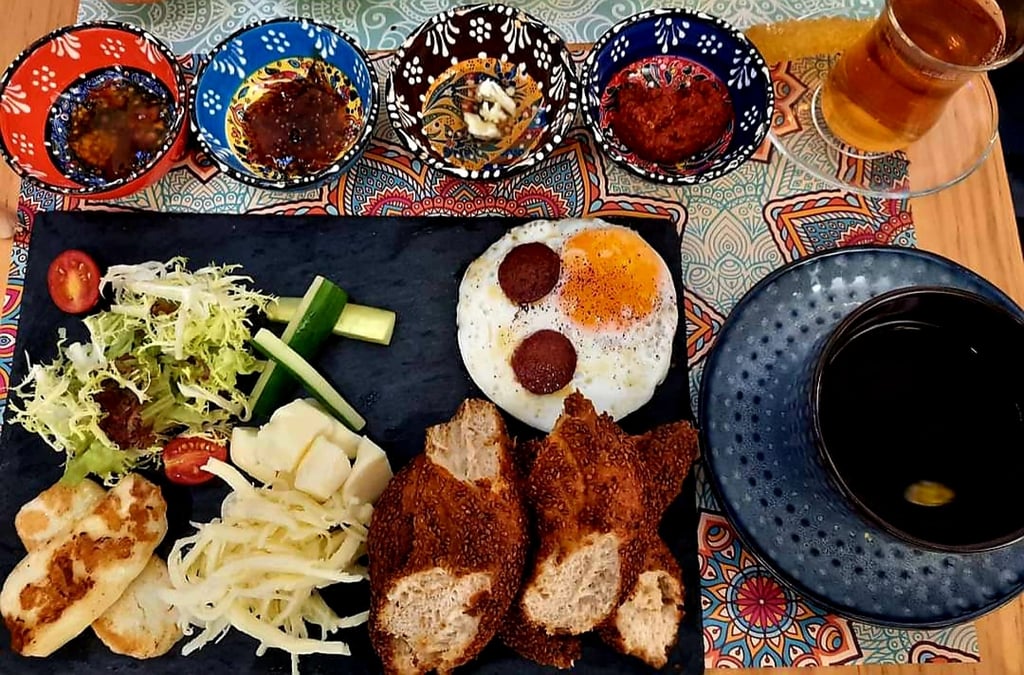The Turkish breakfast at Lonely Paisley: simit (bread), eggs and sausages, three different types of Turkish cheese, four types of jam and honey, and a glass of Turkish tea. Photo: Kam Ling