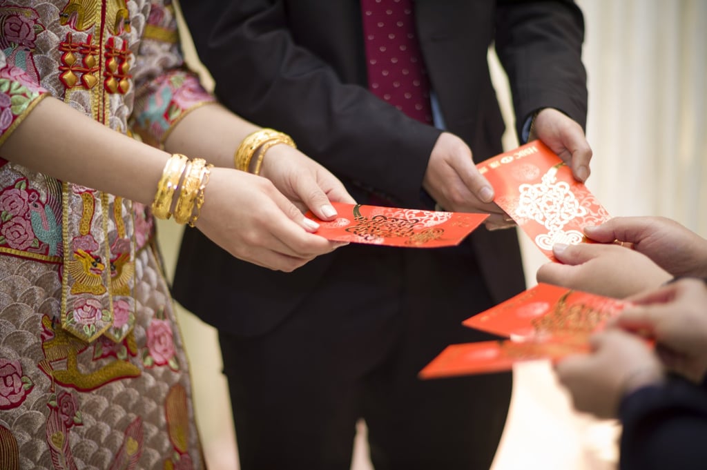 A Chinese groom and bride receiving red packets from parents at a traditional wedding. The red packet represents luck and fortune. Photo: Shutterstock A Chinese groom and bride receiving red packets from parents at a traditional wedding. The red packet represents luck and fortune. Photo: Shutterstock