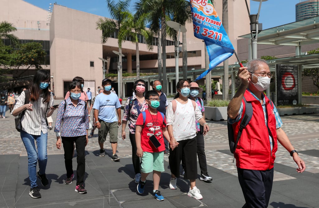 Eat Play Travel guide Lam Kai-wai, alias Uncle Wai, leads members of a local tour group in Tsim Sha Tsui. Photo: Xiaomei Chen Eat Play Travel guide Lam Kai-wai, alias Uncle Wai, leads members of a local tour group in Tsim Sha Tsui. Photo: Xiaomei Chen