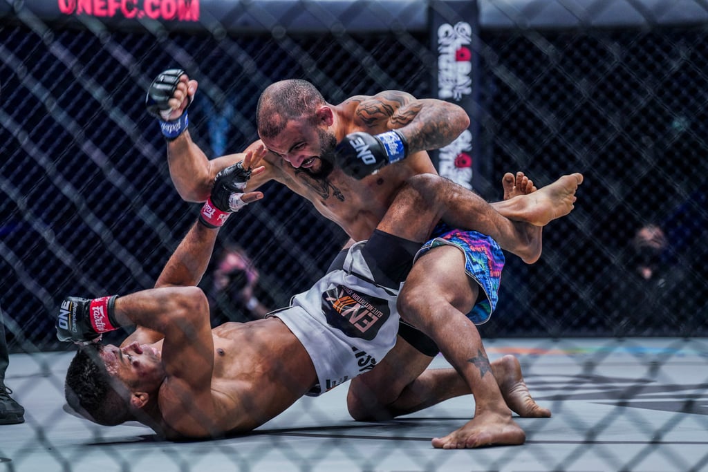 John Lineker ground-and-pounds Bibiano Fernandes in a bantamweight title fight at ONE: Full Circle. John Lineker ground-and-pounds Bibiano Fernandes in a bantamweight title fight at ONE: Full Circle.