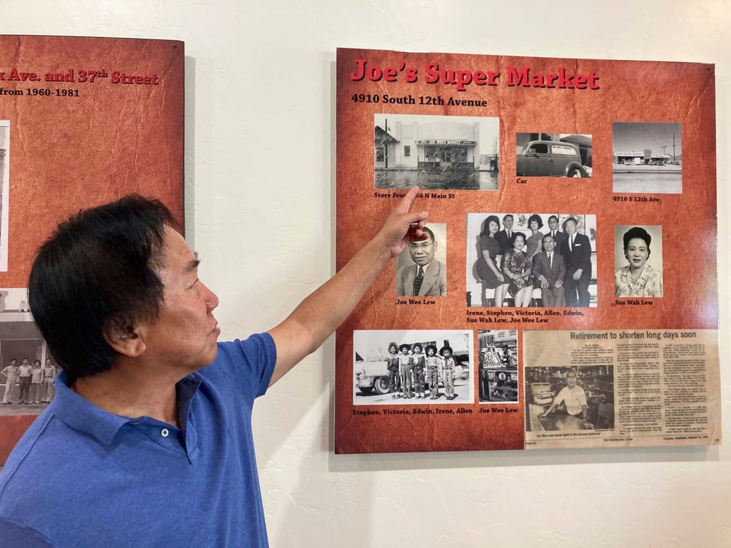 Allen Lew points to a display board at the Tucson Chinese Cultural Centre in Tucson, Arizona, highlighting his father’s grocery store business. Photo: AP/Terry Tang