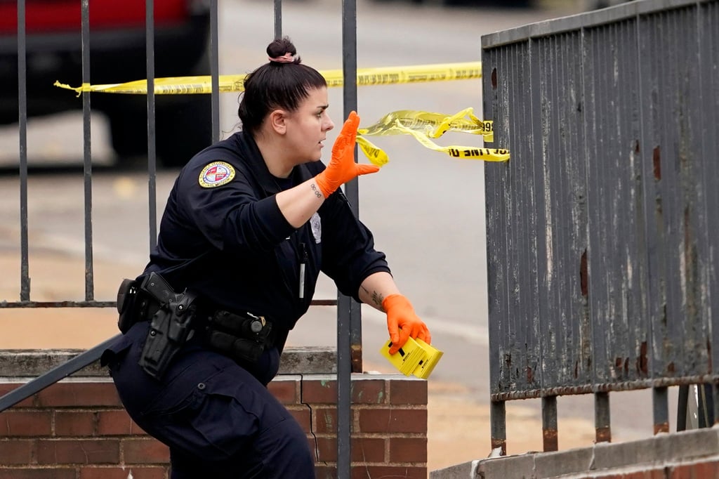 A member of the St Louis Police Department investigates the scene of a shooting at Central Visual and Performing Arts High School on Monday. Photo: AP