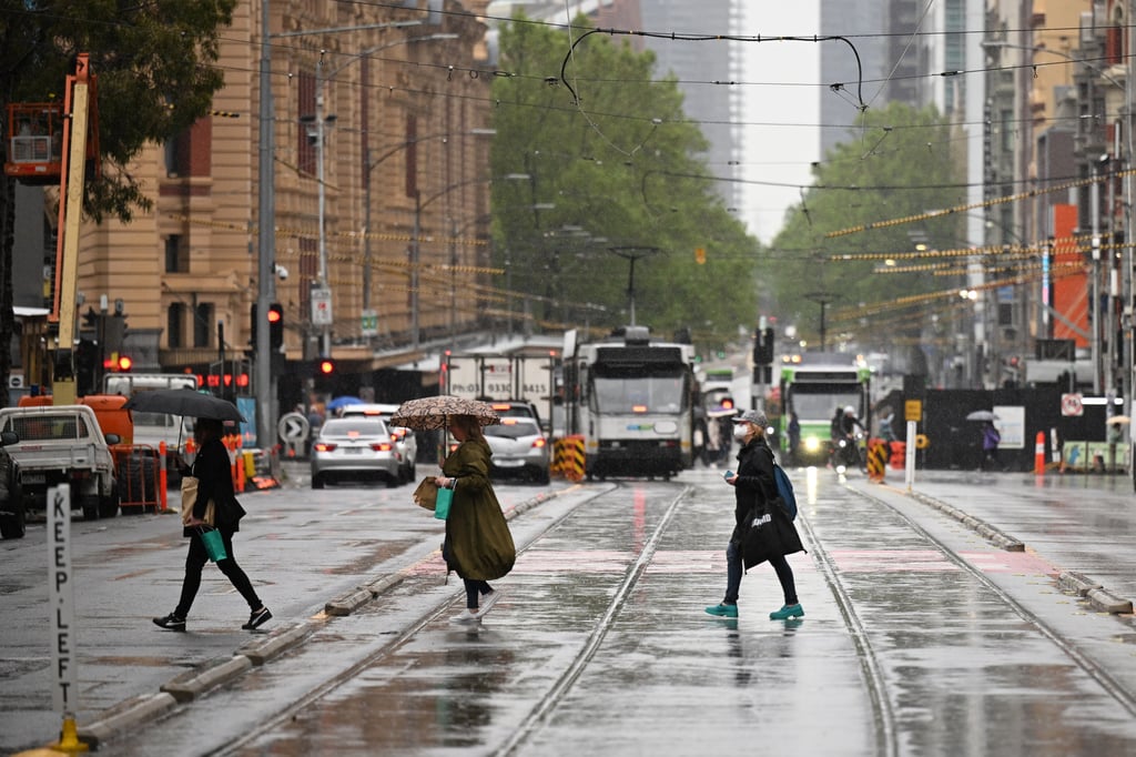 People cross the street in Melbourne on a rainy day. The new study on knee osteoarthritis was presented at the International Congress on Obesity held in the city earlier this month. Photo: AAP/dpa