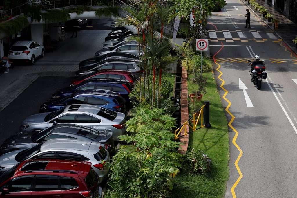 Cars for sale are seen parked at a used car dealership in Singapore this month. The city state limits the number of cars allowed on the roads. Photo: Reuters Cars for sale are seen parked at a used car dealership in Singapore this month. The city state limits the number of cars allowed on the roads. Photo: Reuters