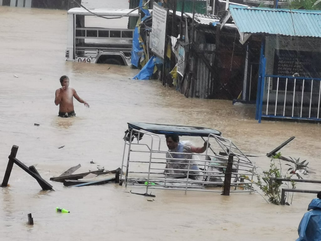 People wade through flood water after Tropical Storm Nalgae raged through Boac, Marinduque Province, Philippines. Photo: Reuters
