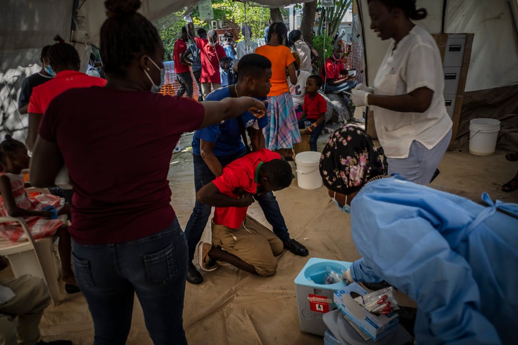 A youth suffering from cholera symptoms is helped upon arrival at a clinic run by Medecins Sans Frontieres in Port-au-Prince, Haiti on Thursday. Photo: AP A youth suffering from cholera symptoms is helped upon arrival at a clinic run by Medecins Sans Frontieres in Port-au-Prince, Haiti on Thursday. Photo: AP