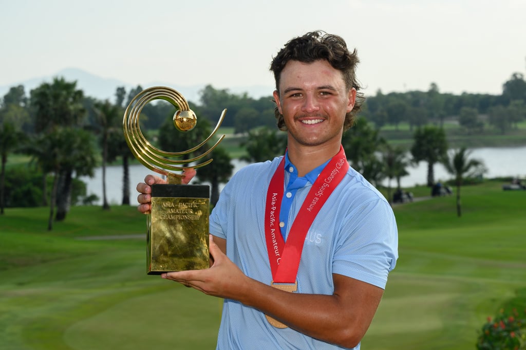 Harrison Crowe of Australia lifts the Asia-Pacific Amateur Championship trophy.