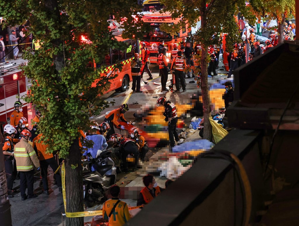 Rescue team and firefighters work on the scene where dozens of people were injured in a stampede during the Halloween festival in Seoul on Saturday. Photo: Yonhap via Reuters Rescue team and firefighters work on the scene where dozens of people were injured in a stampede during the Halloween festival in Seoul on Saturday. Photo: Yonhap via Reuters