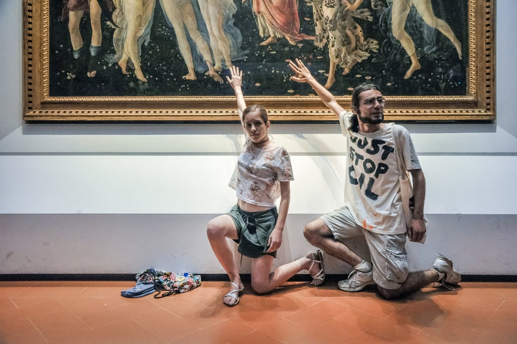 Climate change activists glue their hands to the glass covering Sandro Botticelli’s La Primavera at the Uffizi gallery in Florence, Italy, on July 22, 2022. Photo: Getty Images