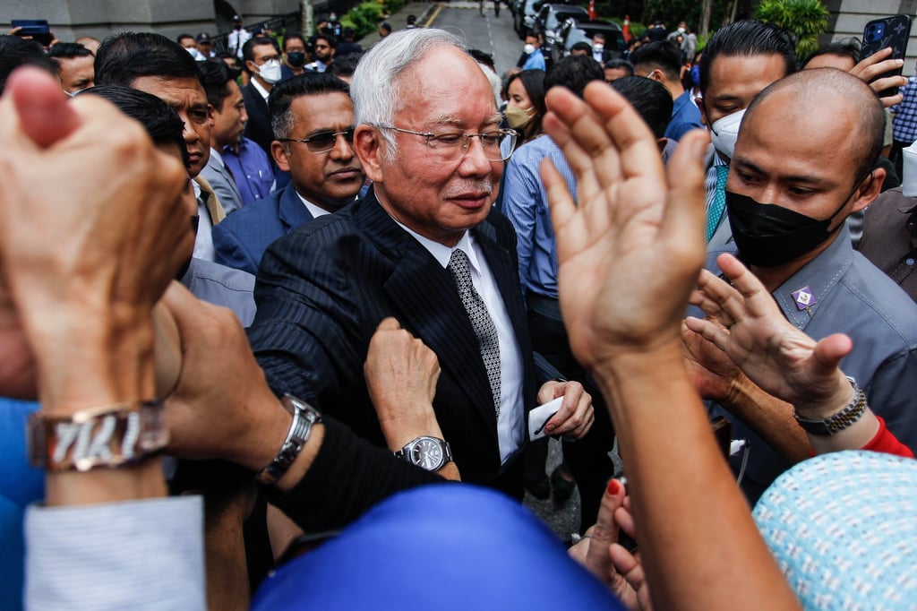 Malaysia’s former prime minister Najib Razak (centre) greets his supporters during a break in his final appeal trial outside the Federal Court in Putrajaya in August 2022. Najib is now serving a 12-year prison sentence. Photo: EPA-EFE