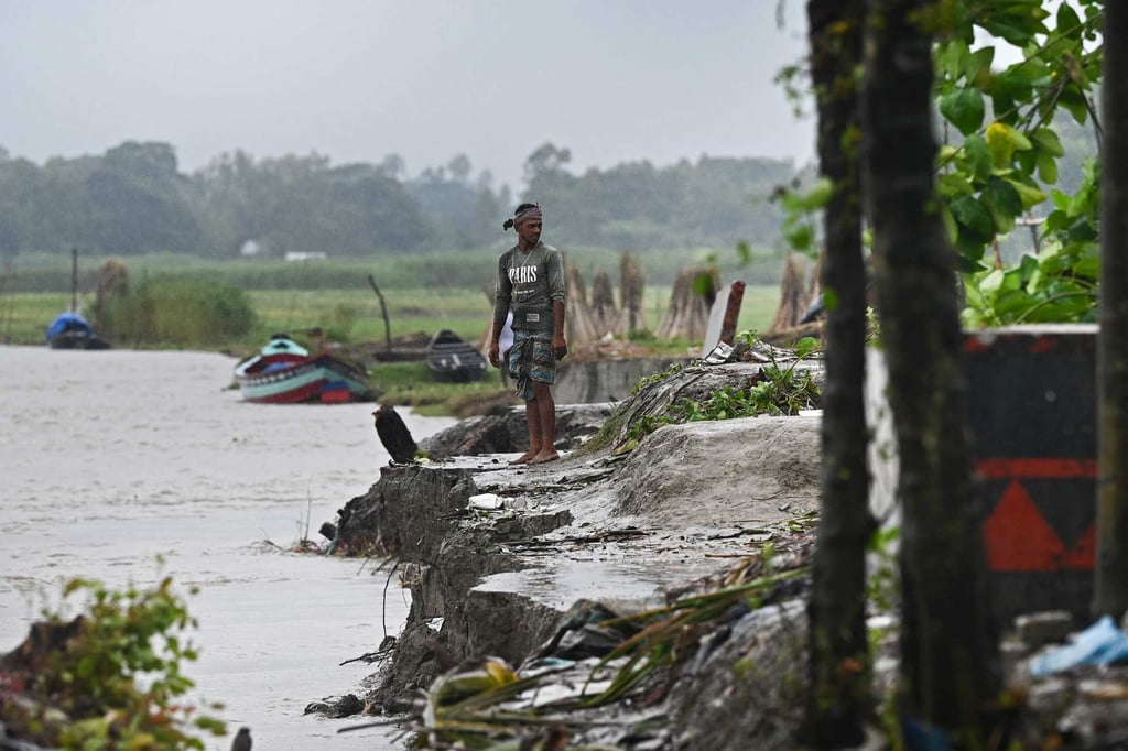 A man stands next to an eroded section on the banks of river Padma in Munshiganj. Periodic flooding that inundates homes, markets and schools has always been a fact of life for the tens of millions of farmers and fishermen who crowd the rivers’ banks – some of the most densely populated areas of the Bangladeshi countryside. Photo: AFP A man stands next to an eroded section on the banks of river Padma in Munshiganj. Periodic flooding that inundates homes, markets and schools has always been a fact of life for the tens of millions of farmers and fishermen who crowd the rivers’ banks – some of the most densely populated areas of the Bangladeshi countryside. Photo: AFP