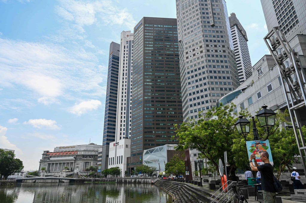 A man takes picture along Boat Quay in Singapore on October 20, 2022. Analysts predict a slump in commercial property transactions could last into the second half of 2023 or longer. Photo: AFP