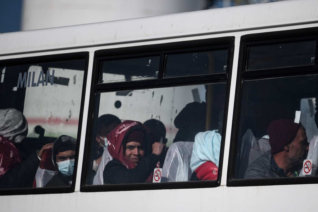 Migrants picked up at sea while attempting to cross the English Channel from France look on from bus driving them to a processing centre at Dover port in Dover, UK. Photo: AFP Migrants picked up at sea while attempting to cross the English Channel from France look on from bus driving them to a processing centre at Dover port in Dover, UK. Photo: AFP