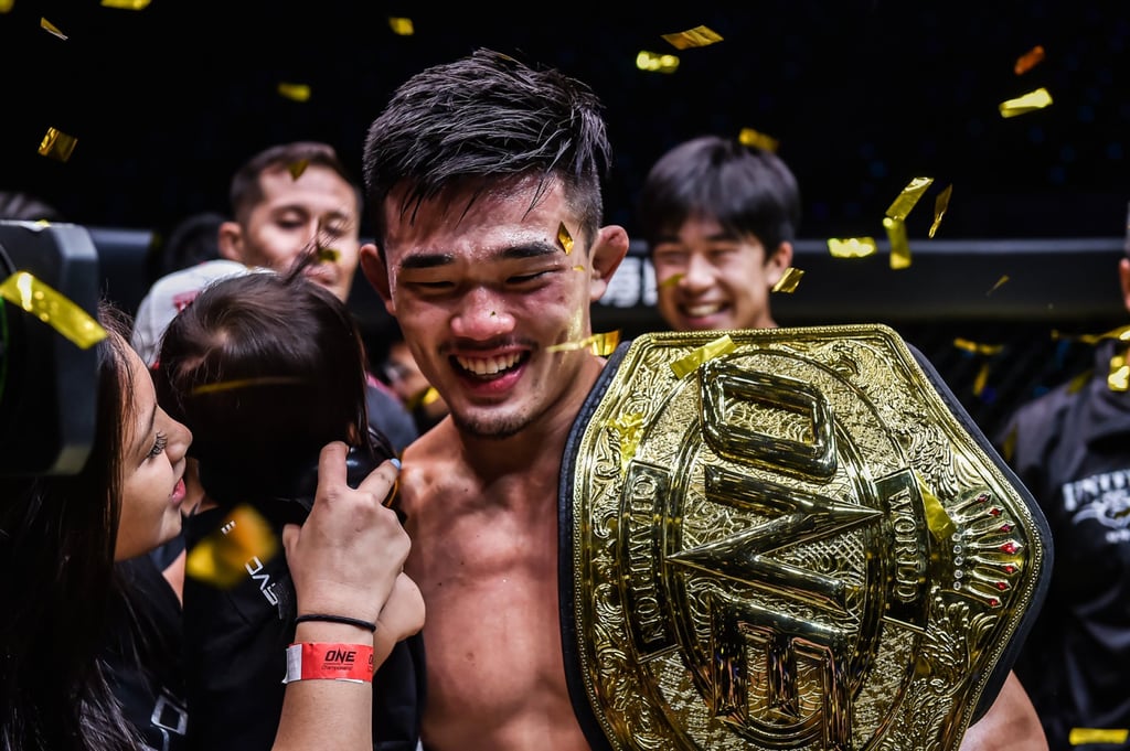 Christian Lee celebrates with his wife and daughter after reclaiming the ONE lightweight title with a TKO of Ok Rae-yoon. Christian Lee celebrates with his wife and daughter after reclaiming the ONE lightweight title with a TKO of Ok Rae-yoon.