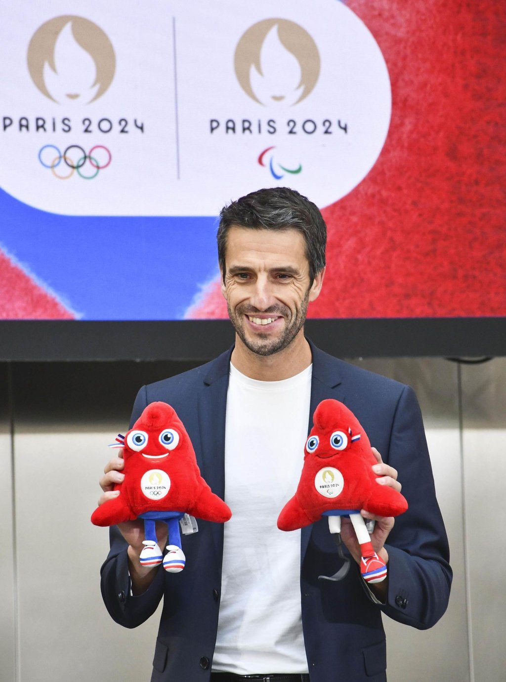 Tony Estanguet, president of the Paris 2024 Olympics organising committee, holds up replicas of Phrygian caps. The bright red cap was a symbol of liberty in the French Revolution. Photo: Kyodo