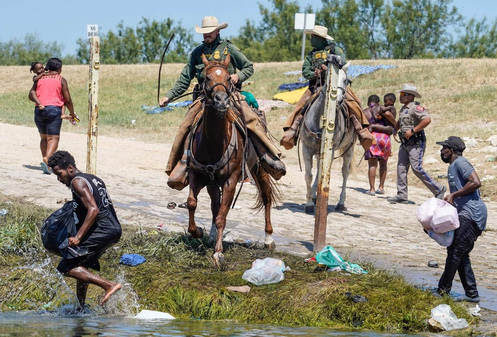 United States Border Patrol agents on horseback chase Haitian migrants near the banks of the Rio Grande in Del Rio, Texas, last year. Photo: AFP