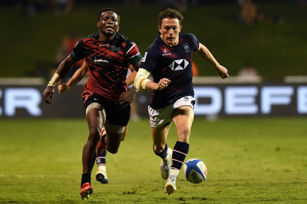 Jack Neville of Hong Kong and Bryceson Adaka of Kenya chase down a loose ball. Photo: World Rugby via Getty Images Jack Neville of Hong Kong and Bryceson Adaka of Kenya chase down a loose ball. Photo: World Rugby via Getty Images