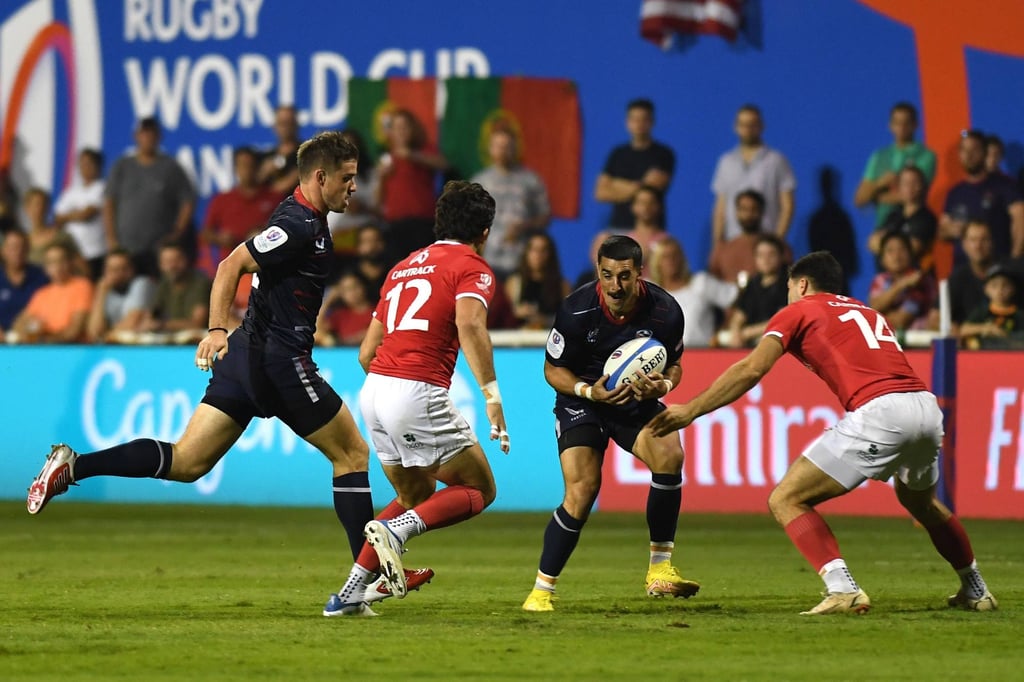 The USA’s Nate Augspurger runs at Tomas Appleton (left) and Raffaele Storti of Portugal during the game in Dubai. Photo: World Rugby