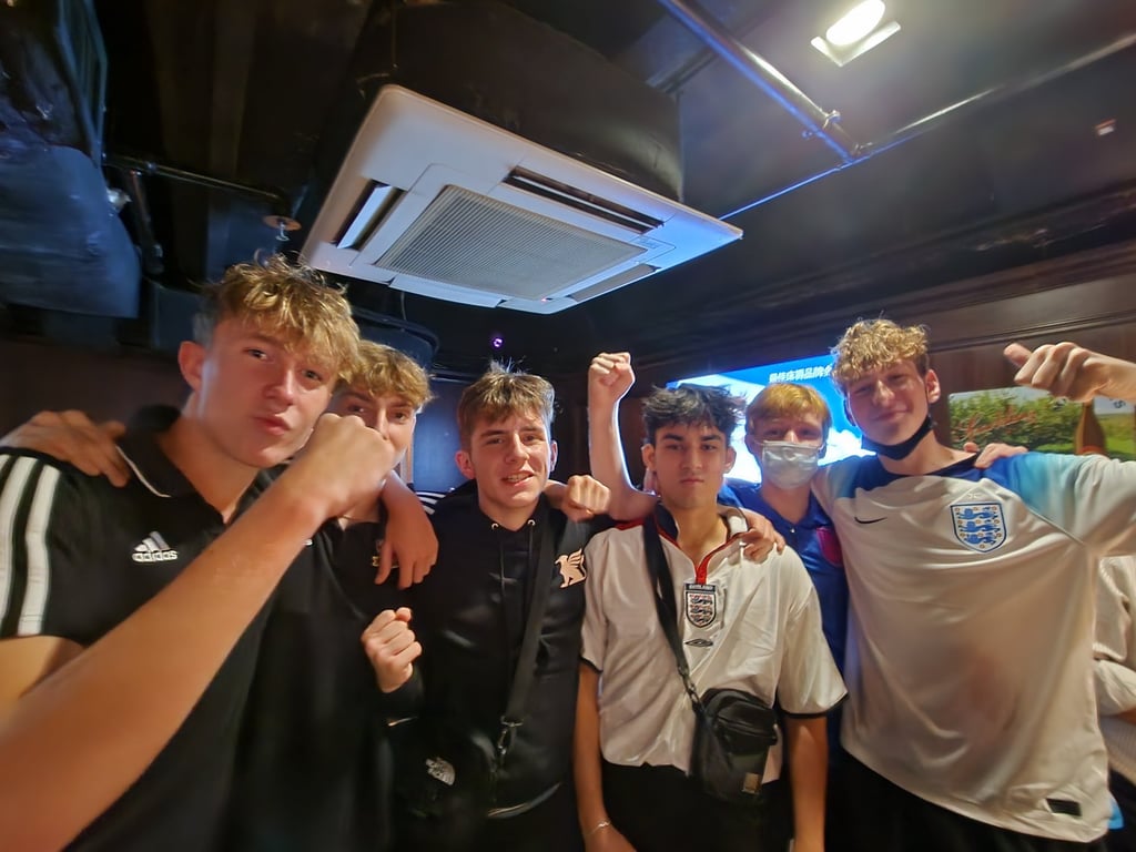 Edward Langston, 18 (second from right) watches his first World Cup in Wan Chai’s Queen Victoria pub with a group of friends. Photo: Jess Ma