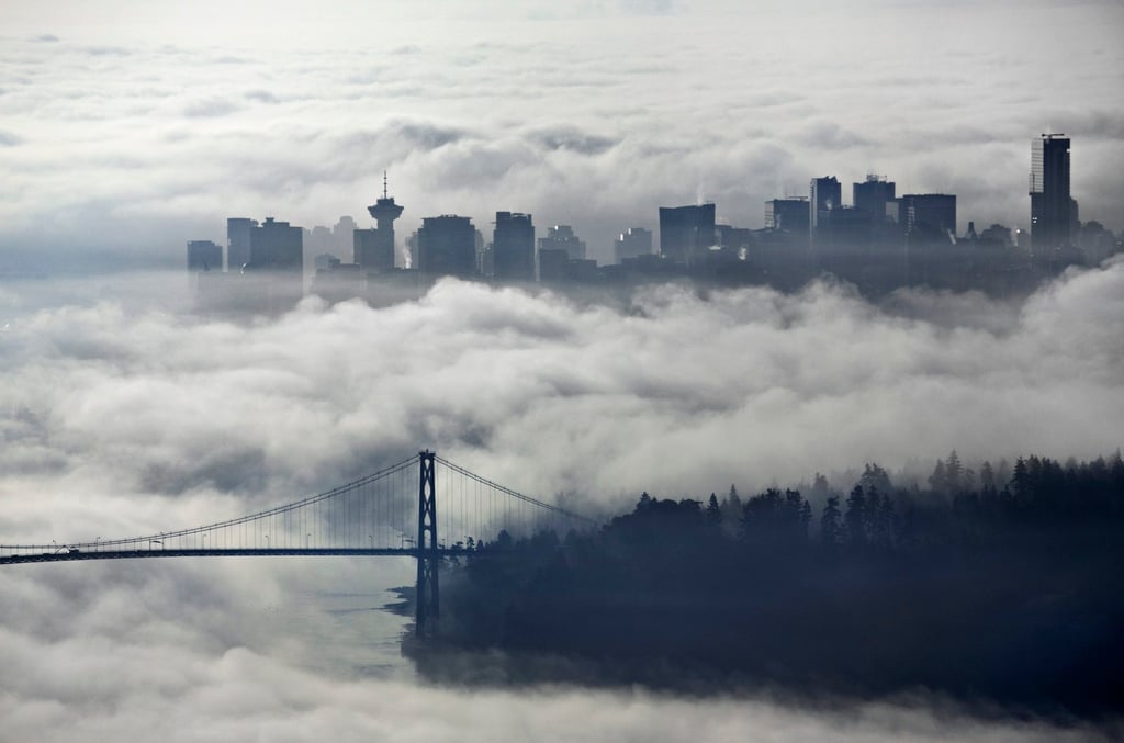 Downtown Vancouver and Lions Gate Bridge, enveloped in morning fog. Photo: Reuters Downtown Vancouver and Lions Gate Bridge, enveloped in morning fog. Photo: Reuters