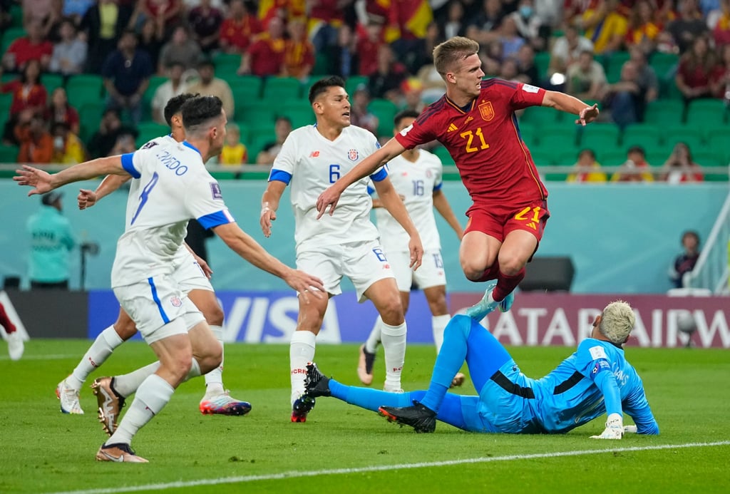 Spain’s Dani Olmo (right) jumps over Costa Rica’s goalkeeper Keylor Navas to score his side’s first goal during the World Cup group E soccer match between Spain and Costa Rica at the Al Thumama Stadium in Doha on Wednesday. Photo: AP Spain’s Dani Olmo (right) jumps over Costa Rica’s goalkeeper Keylor Navas to score his side’s first goal during the World Cup group E soccer match between Spain and Costa Rica at the Al Thumama Stadium in Doha on Wednesday. Photo: AP