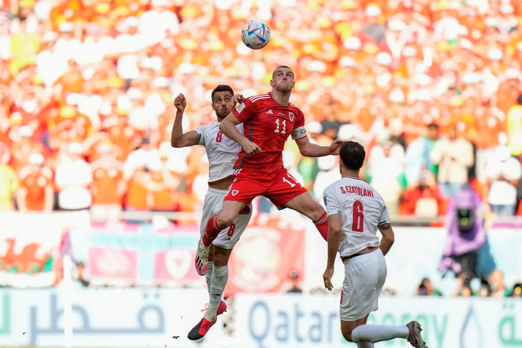 Iran’s Morteza Pouraliganji (left) and Wales’ Gareth Bale both jump for the ball during their side’s Group B match at the Ahmad Bin Ali Stadium in Al Rayyan. Photo: AP Iran’s Morteza Pouraliganji (left) and Wales’ Gareth Bale both jump for the ball during their side’s Group B match at the Ahmad Bin Ali Stadium in Al Rayyan. Photo: AP