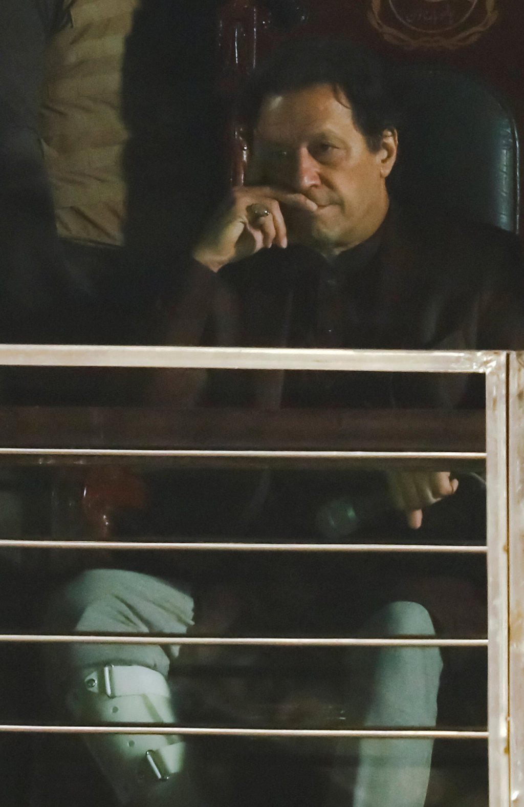 Pakistan’s former Prime Minister, Imran Khan, gestures from behind a bulletproof glass window, in his first public appearance since him being wounded in a gun attack earlier this month. Photo: Reuters