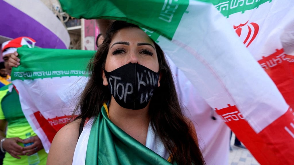 A woman wearing a mask with a message reading ‘stop killing us’ after the World Cup football match between Wales and Iran. Photo: Reuters