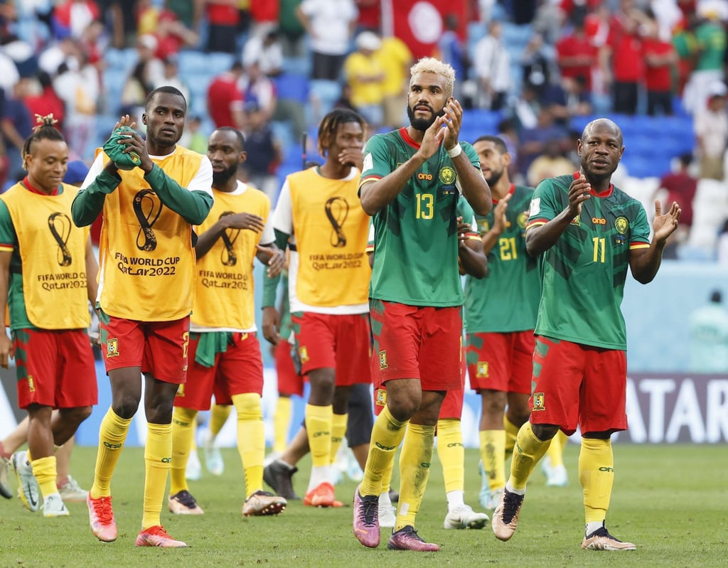 Cameroon players acknowledge the crowd after battling to a 3-3 draw against Serbia. Photo: Kyodo