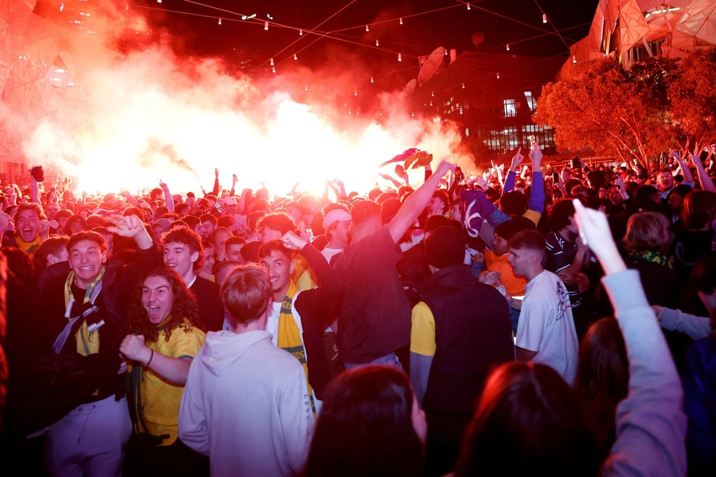 Socceroos fans celebrate at Federation Square in Melbourne after Australia score their goal. Photo: Reuters Socceroos fans celebrate at Federation Square in Melbourne after Australia score their goal. Photo: Reuters