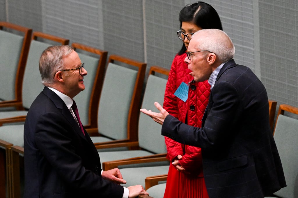Professor Sean Turnell and his wife Dr. Ha Vu talk with Australian Prime Minister Anthony Albanese, left, during Question Time in the House of Representatives at Parliament House in Canberra, Australia on Thursday. Photo: AP Professor Sean Turnell and his wife Dr. Ha Vu talk with Australian Prime Minister Anthony Albanese, left, during Question Time in the House of Representatives at Parliament House in Canberra, Australia on Thursday. Photo: AP