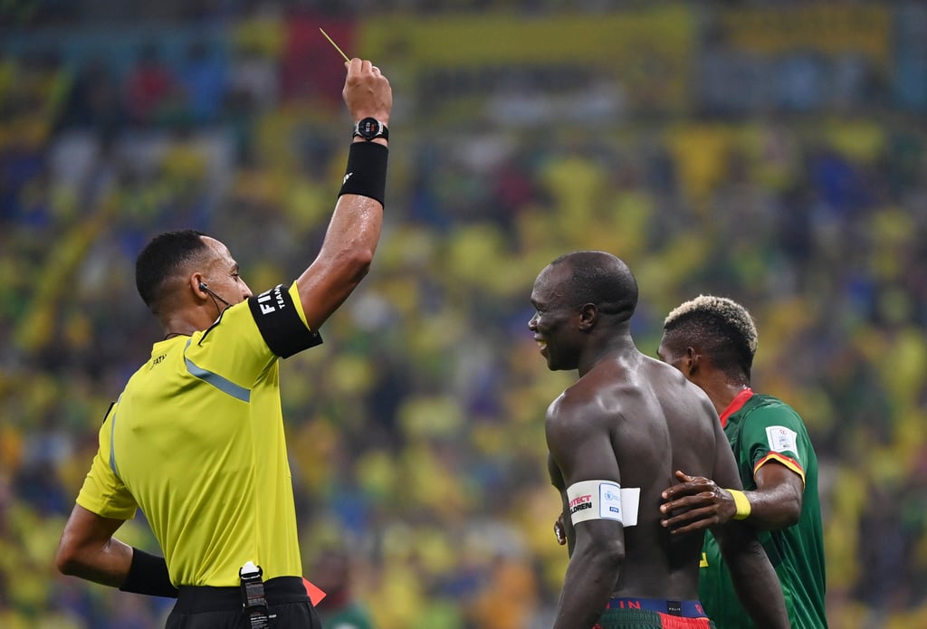 Referee Ismail Elfath shows a yellow card to Vincent Aboubakar of Cameroon after he took off his jersey to celebrate scoring against Brazil. Photo: Xinhua